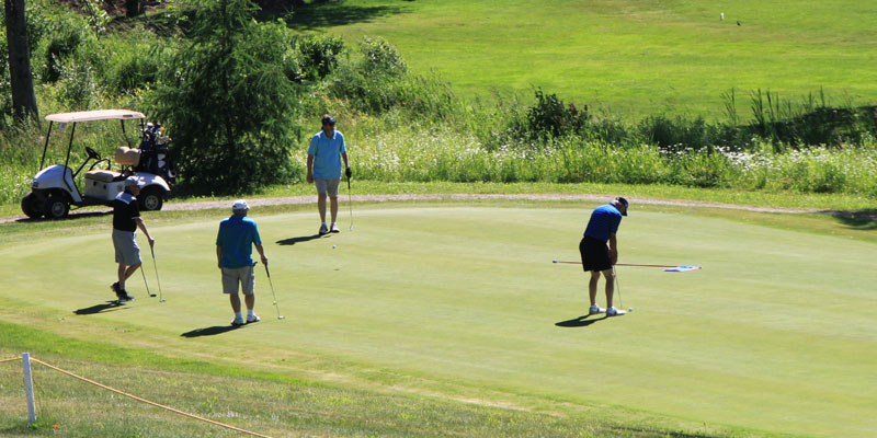 Photos of four golfers playing in league on hole #10 at Tamarack Golf Club.