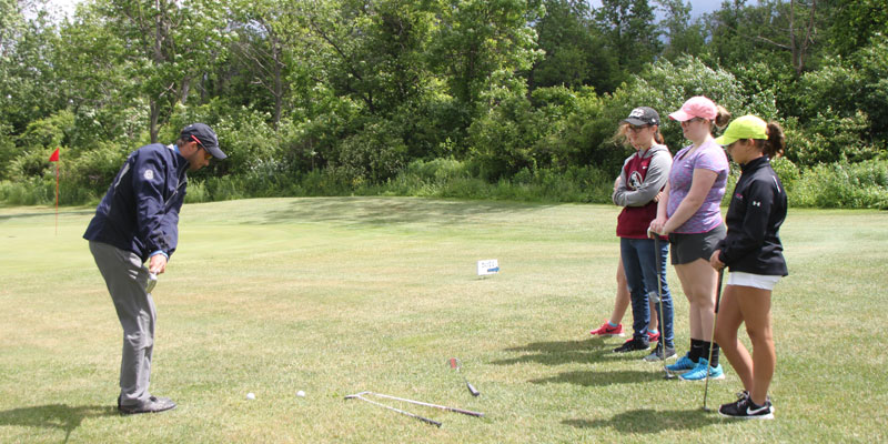 Photo of golf lessons on the range.