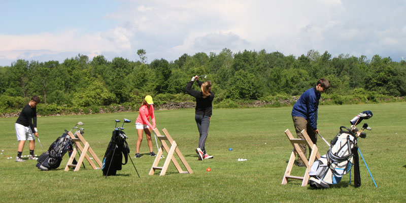 Photo of golf lessons on the range.